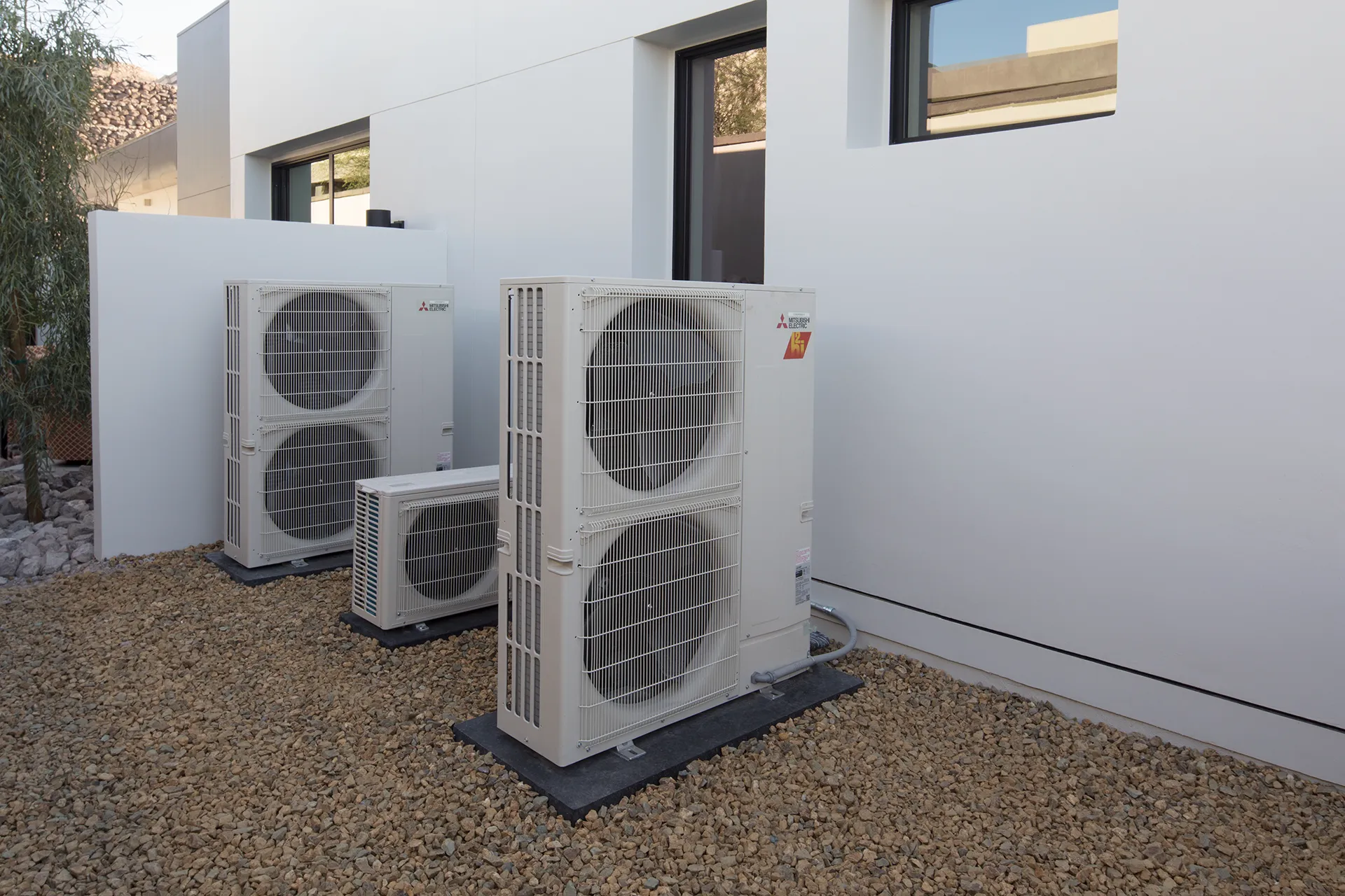 Three outdoor heat pump units outside residential home