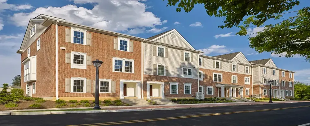 Village Square home house architecture building residential suburb driveway suburban family window street brick mortgage garage realty estate facade yard upscale lawn